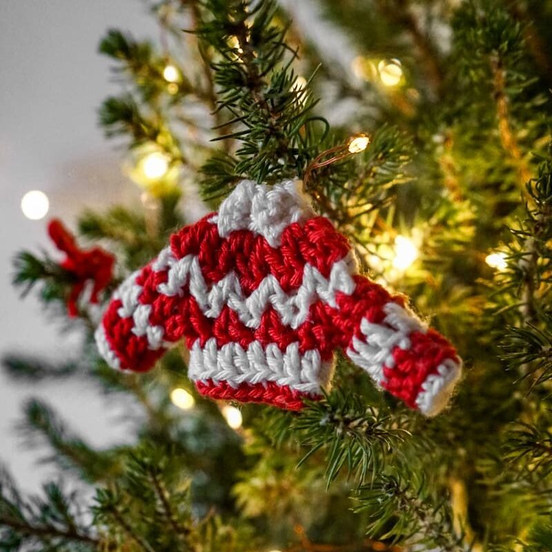 a knitted ornament hanging from a christmas tree